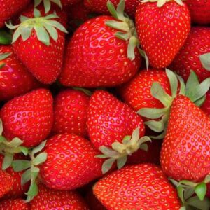 Fresh, ripe strawberries with green leaves.